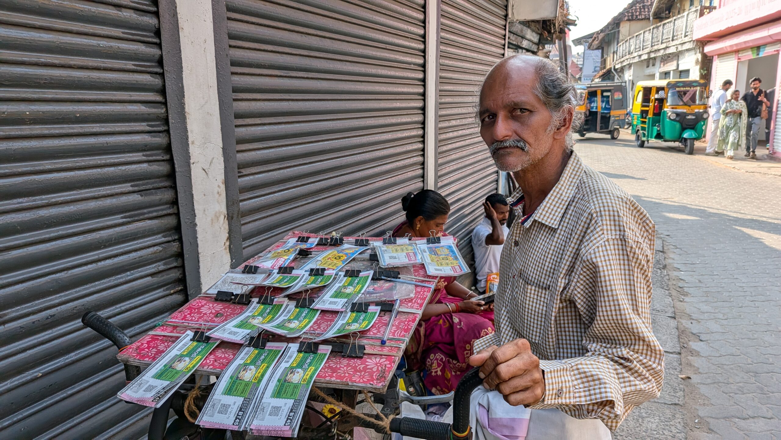 A Kerala state lottery ticket seller with his cart of tickets in Mattancherry, Fort Kochi