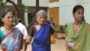 An elderly woman being helped across a courtyard in Visakhapatnam, Andhra Pradesh, representative of the age group NTR Bharosa old-age pensions serve