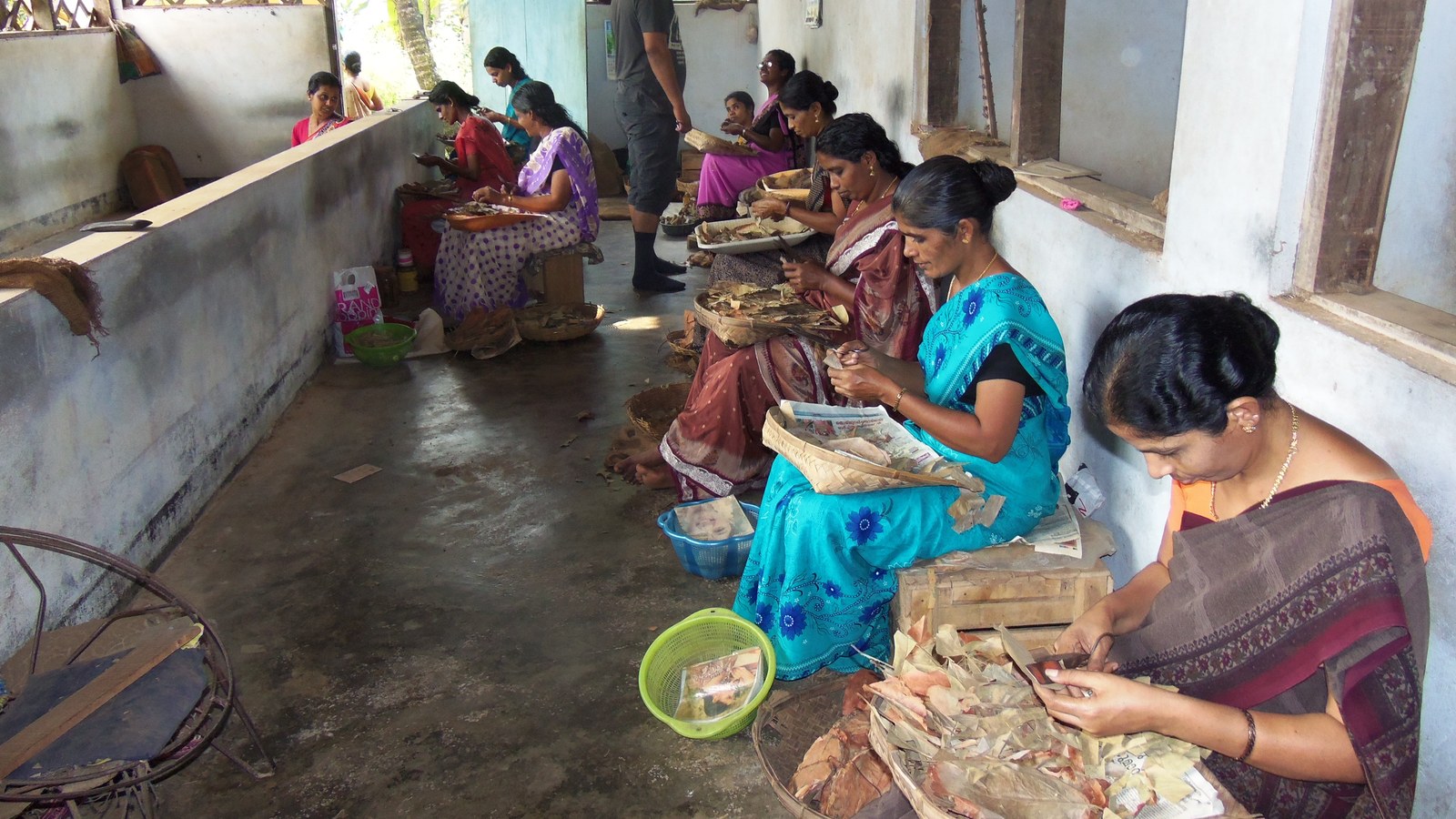 Women workers in India hand-rolling beedis at a small factory, representative of the lower-wage workforce the EPF wage ceiling change targets