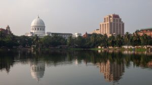 The domed General Post Office building and the Reserve Bank of India tower in Kolkata, reflected in the Lal Dighi tank, the postal and banking institutions both central to this weeks advance salary and pension disbursement