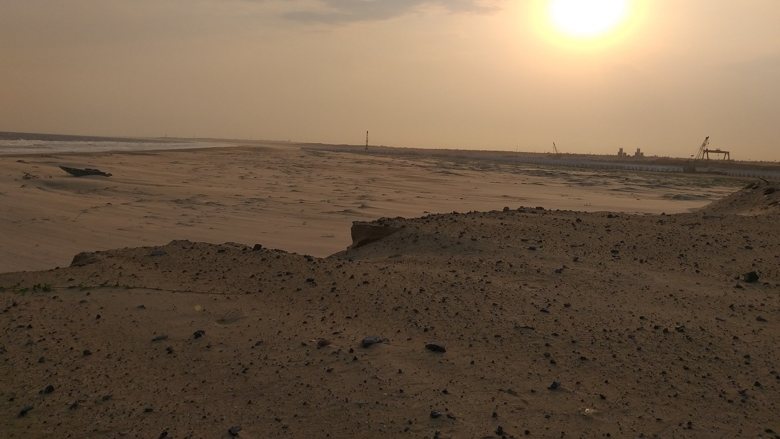 A beached fishing boat and hazy sunset sky over Gopalpur beach and port in Ganjam district, Odisha, the coastal point IMD is measuring the Bay of Bengal depression against