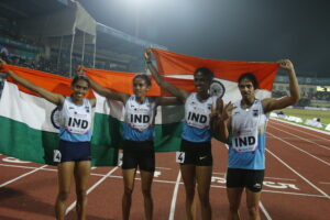 India's women's 4x400m relay team hold up the Indian flag and celebrate a gold medal on the track at the 2017 Asian Athletics Championships in Bhubaneswar