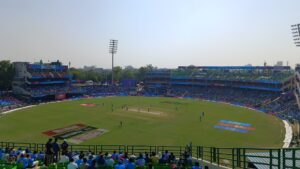 Packed crowd watches an India vs Afghanistan cricket match at Arun Jaitley Stadium in Delhi, with the stadium's name visible on the stand