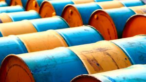 Rows of crude oil barrels stacked at an industrial storage yard