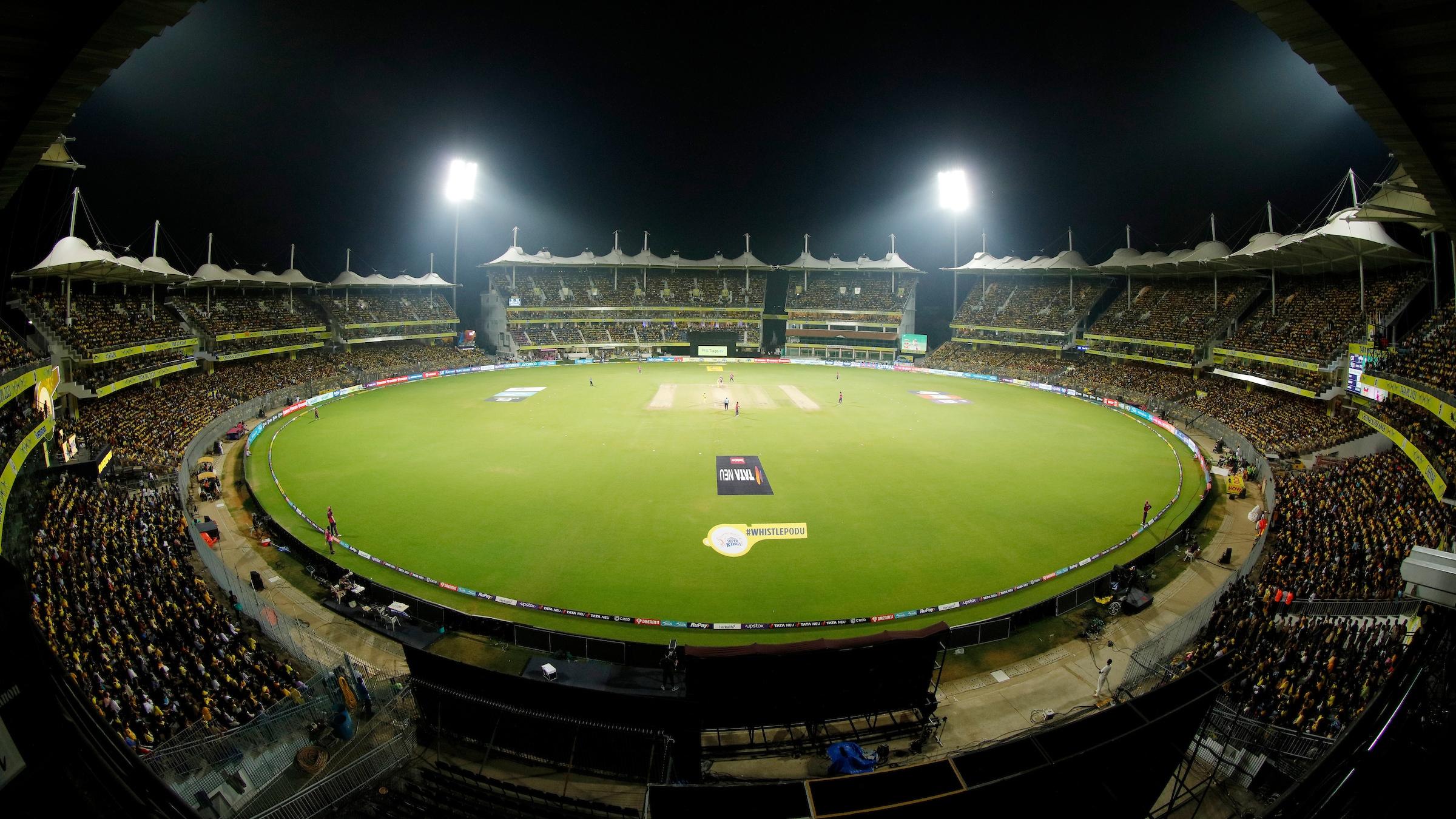 MA Chidambaram Stadium in Chennai lit up at night for a Chennai Super Kings home match, with the stands packed in yellow