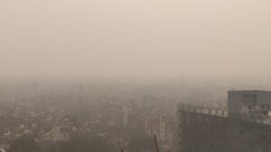 Thick grey smog hanging over rooftops and buildings across Delhi during a winter pollution episode in 2019
